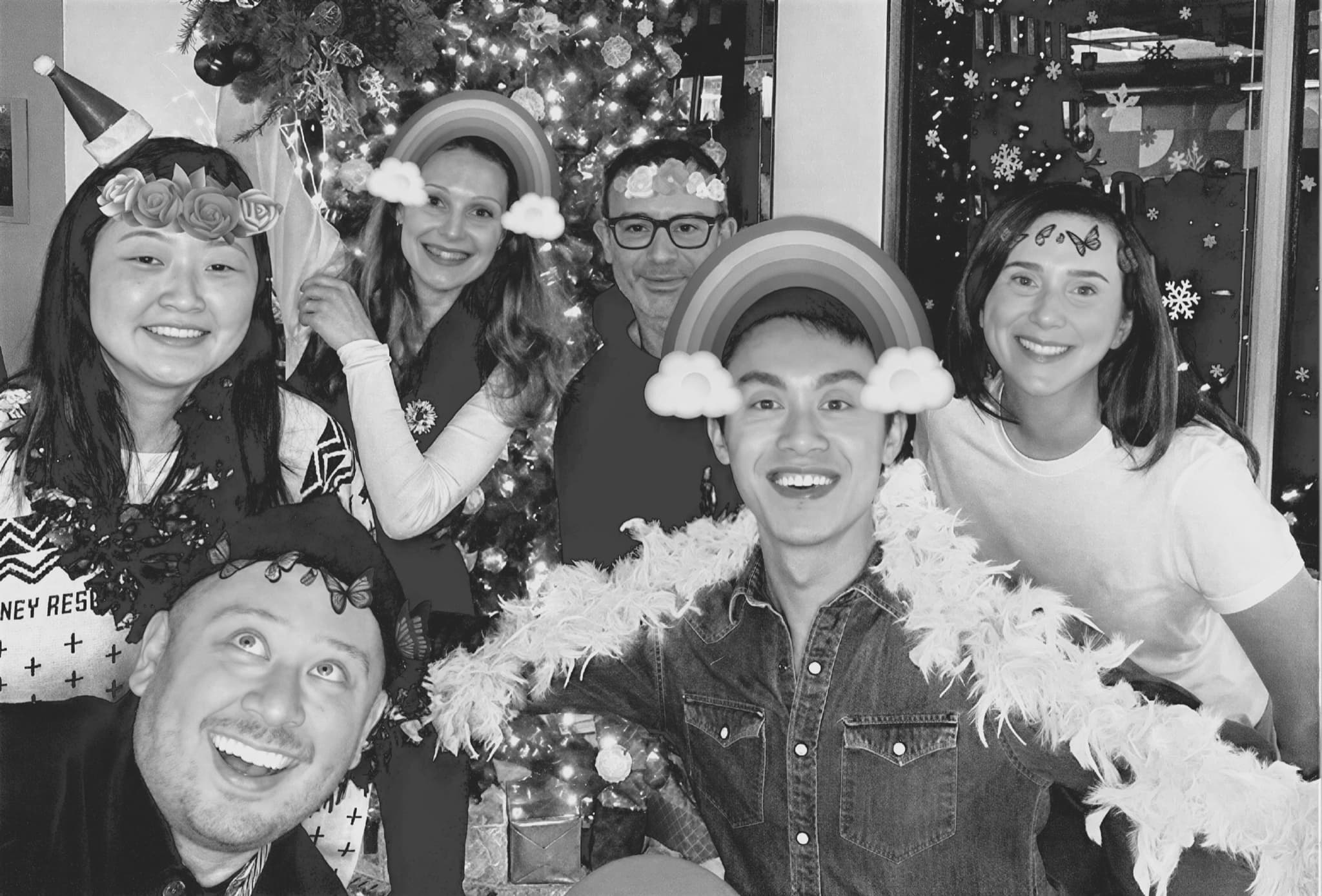 Six teammates together in playful holiday costumes.